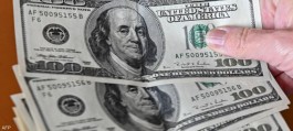 The dollar holds near an 8-day high, supported by US inflation data.