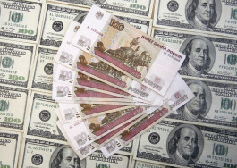 The ruble fell to more than 100 against the dollar, and the Kremlin attributed the reason to monetary easing